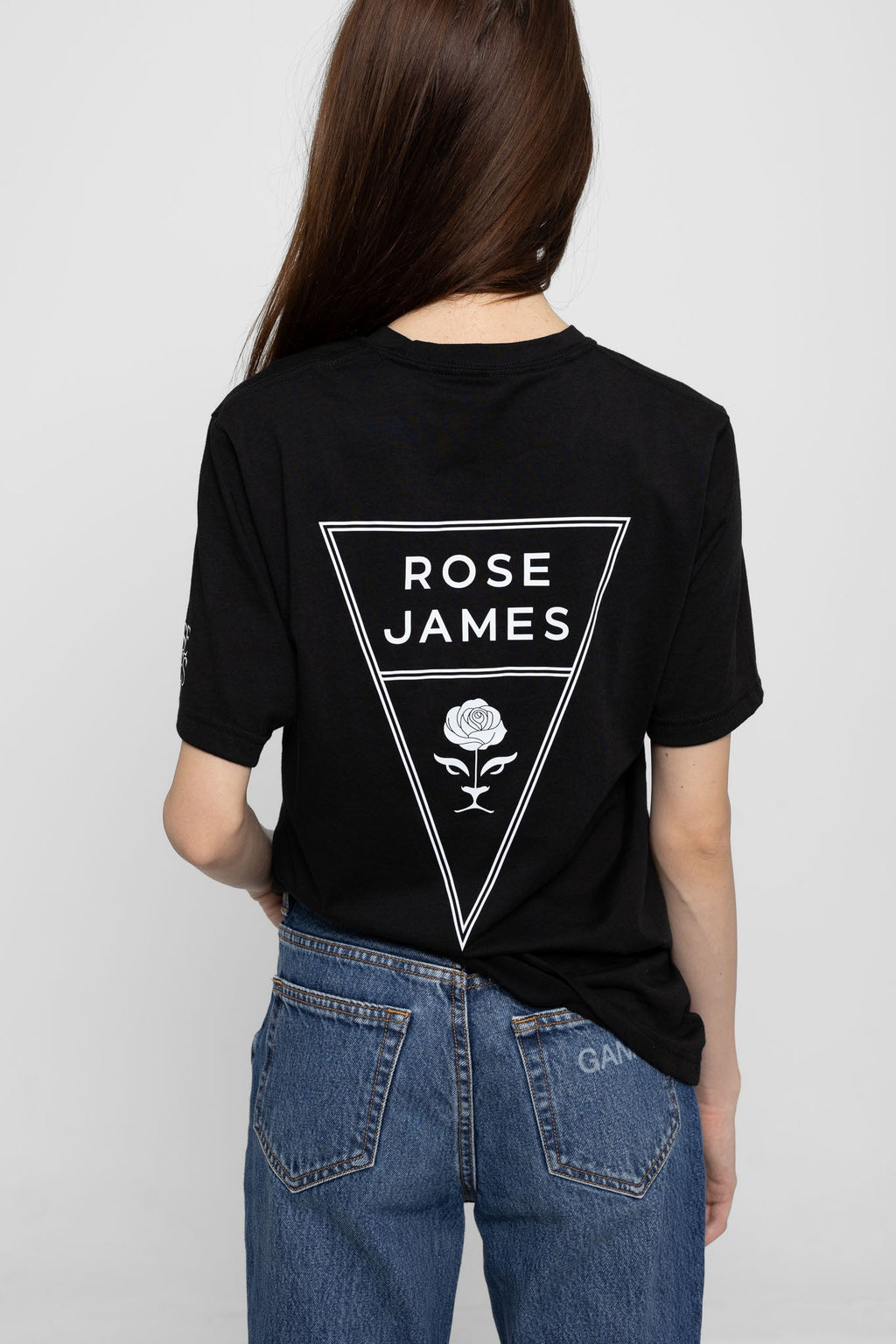 Person wearing a black t-shirt with 'Rose James' logo on the back, standing against a plain background.