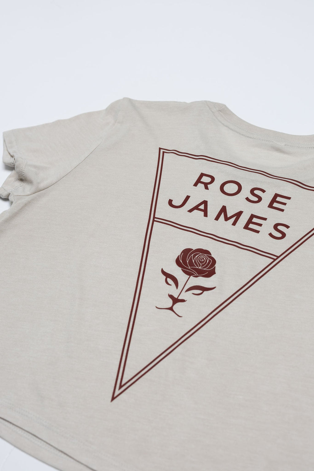 Beige t-shirt with 'Rose James' logo on a white background