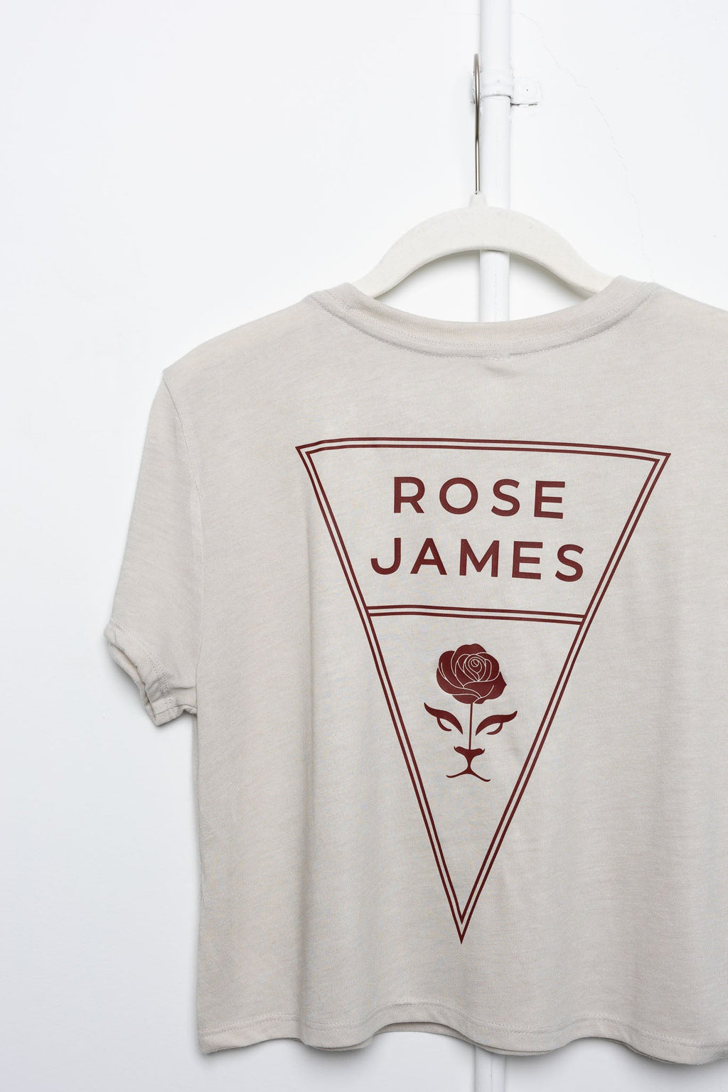 Beige t-shirt with 'Rose James' logo on a white background