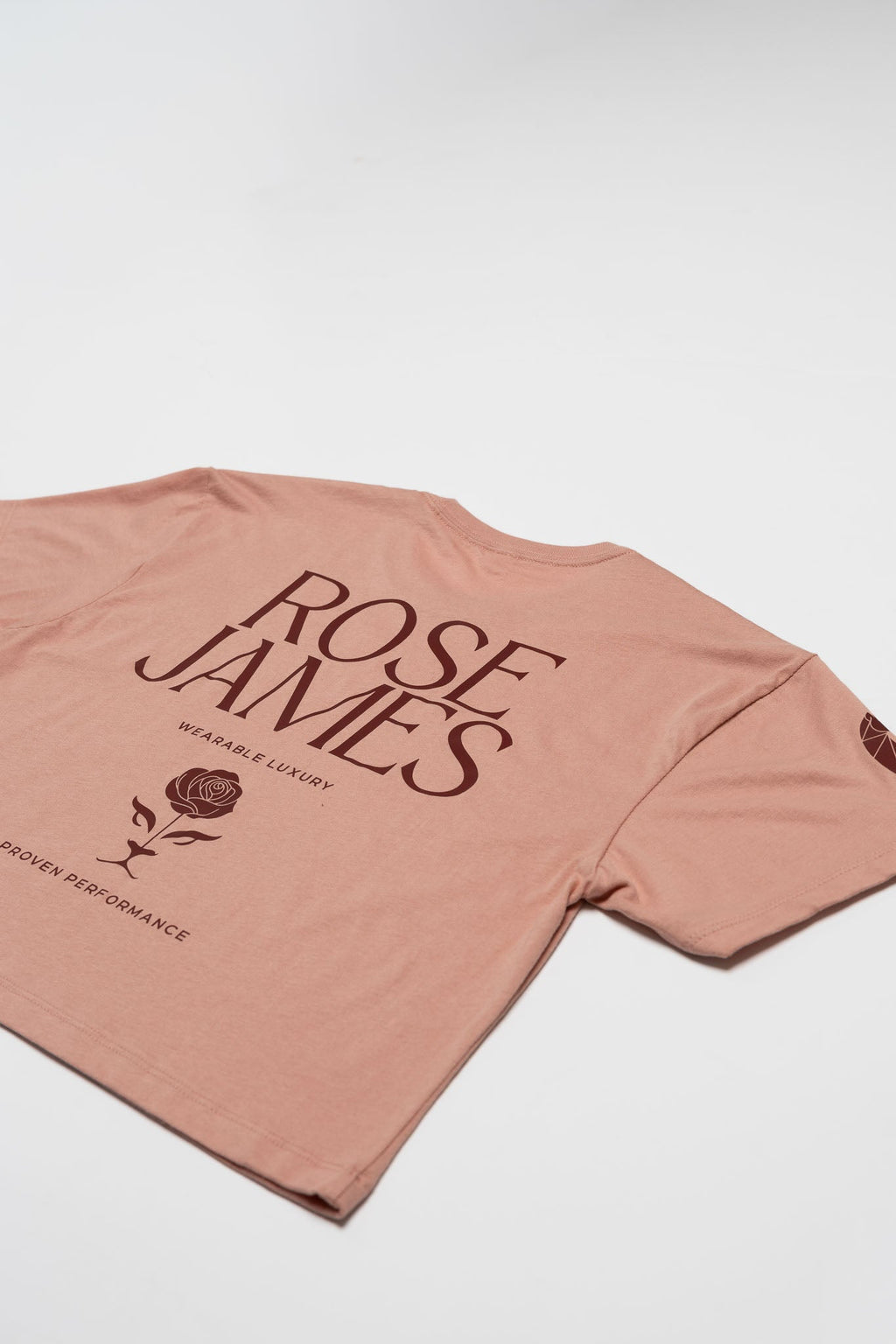 Pink t-shirt with 'Rose James' branding on a white background