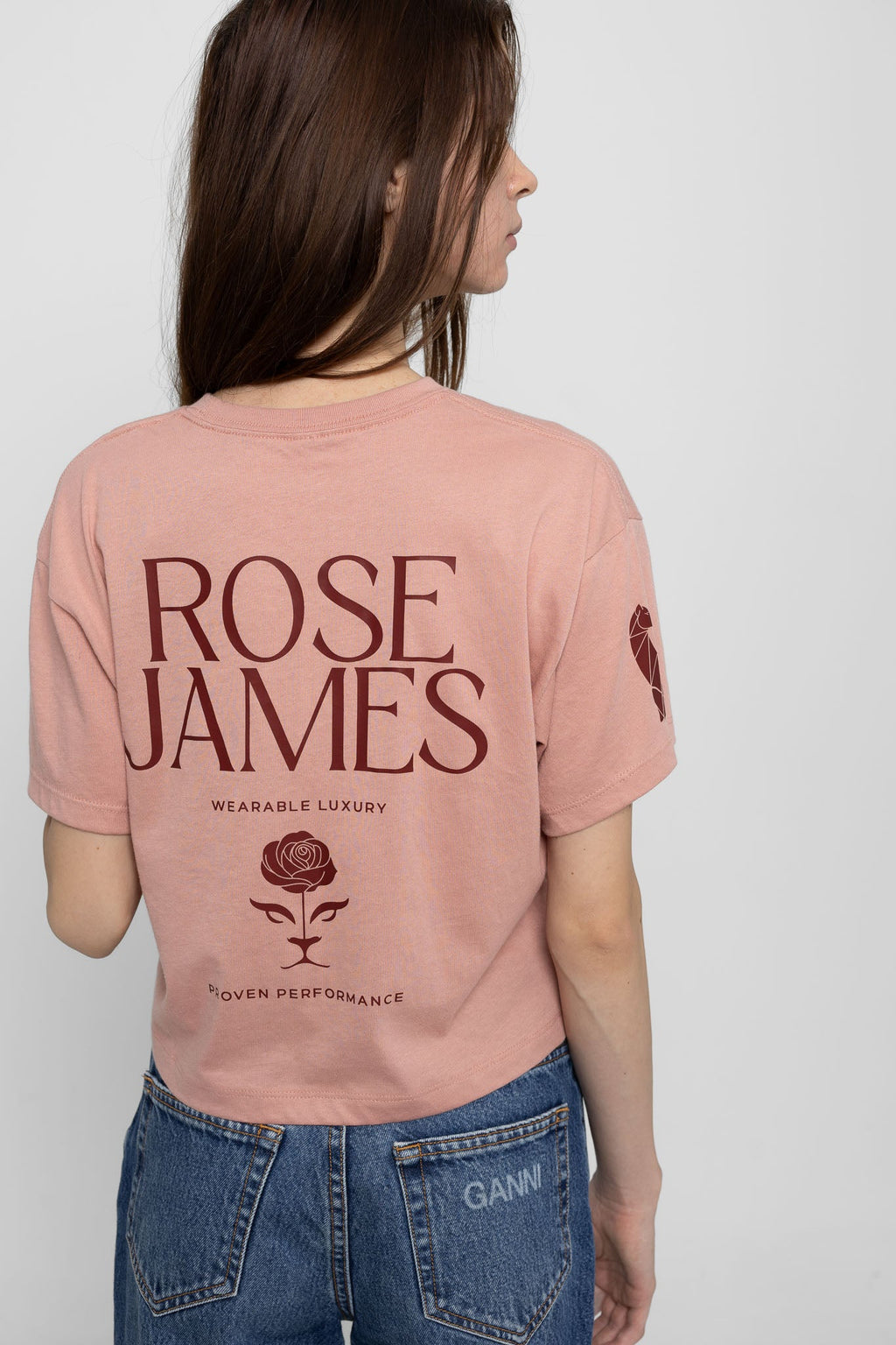 Person wearing a pink t-shirt with 'Rose James' branding on the back.